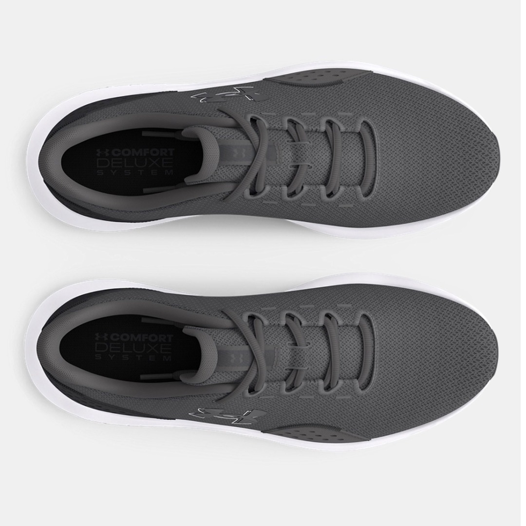 Top view of gray sports sneakers with a textured finish and white soles, featuring a "Comfort Deluxe System" label inside.