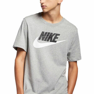 A young man wearing a gray Nike graphic t-shirt featuring the brand logo, posed in casual attire.